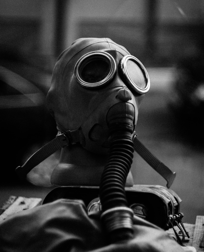 Grayscale image showcasing a vintage gas mask on display, emphasizing safety and protection themes.